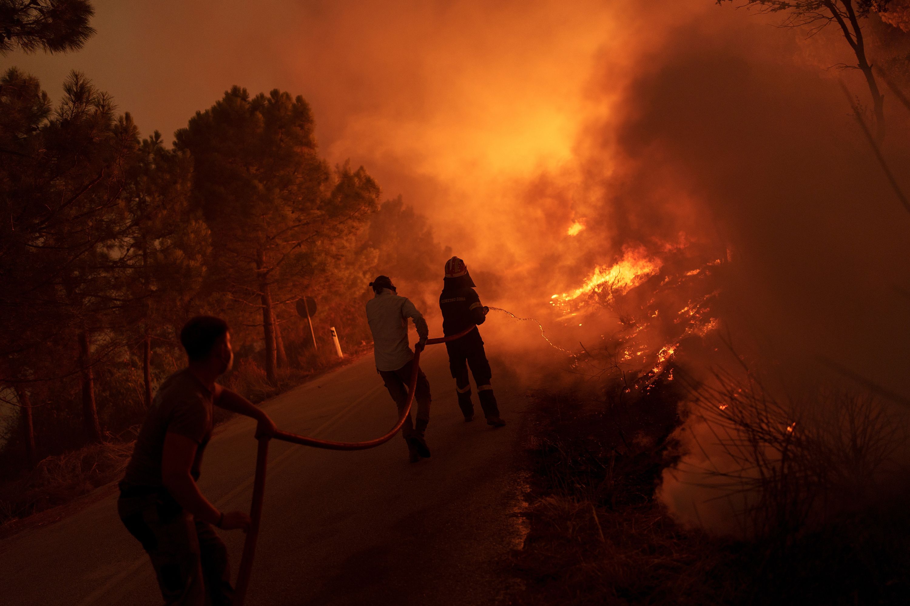 Hundreds of firefighters battle raging Greek wildfires